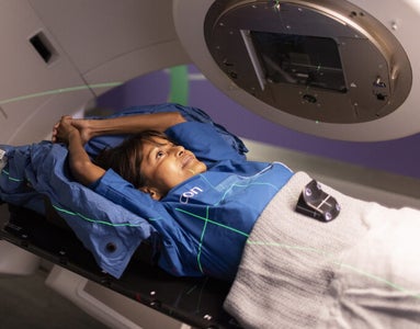 Photo of an Icon Cancer Centre patient on a scanning bed