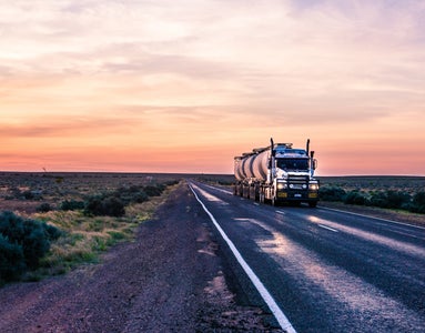 Large truck travelling on a long open road