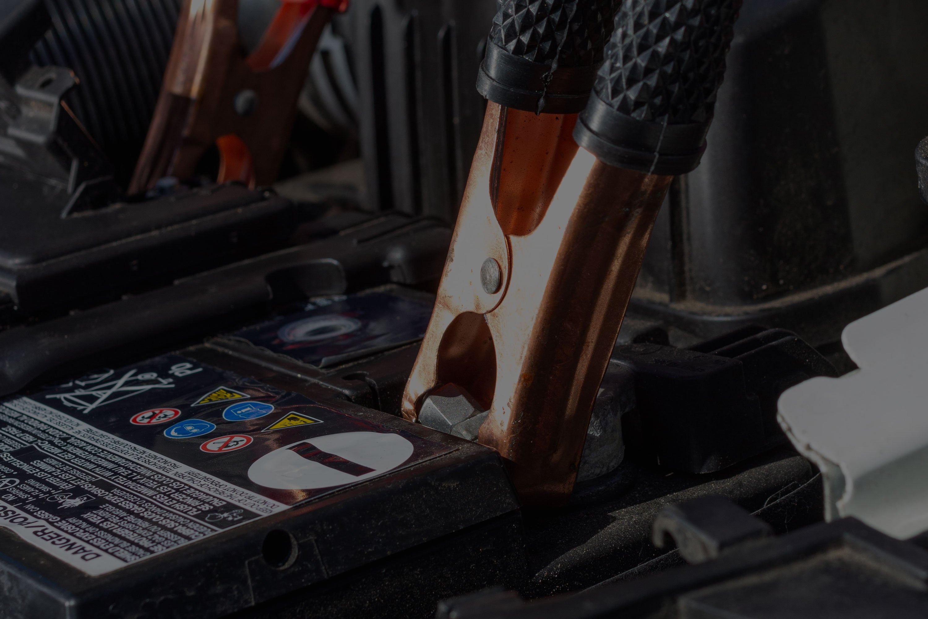 Jumper cables attached to a car battery