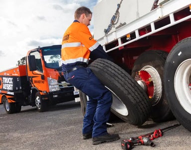 Truck Assist employee changing a truck tyre