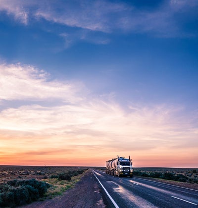 Large truck travelling on a long and open road