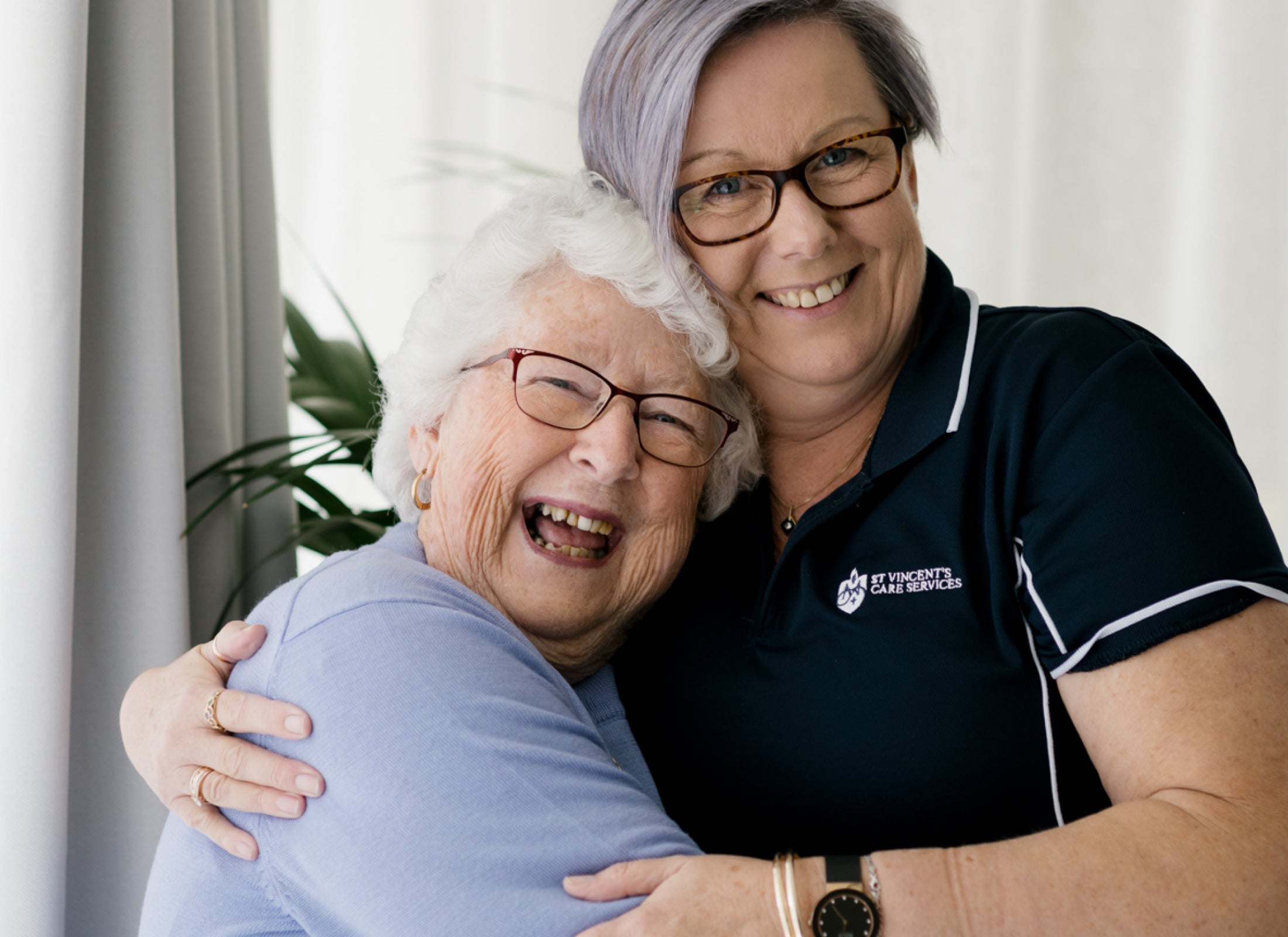 Elderly patient with a caring St Vincent's staff member