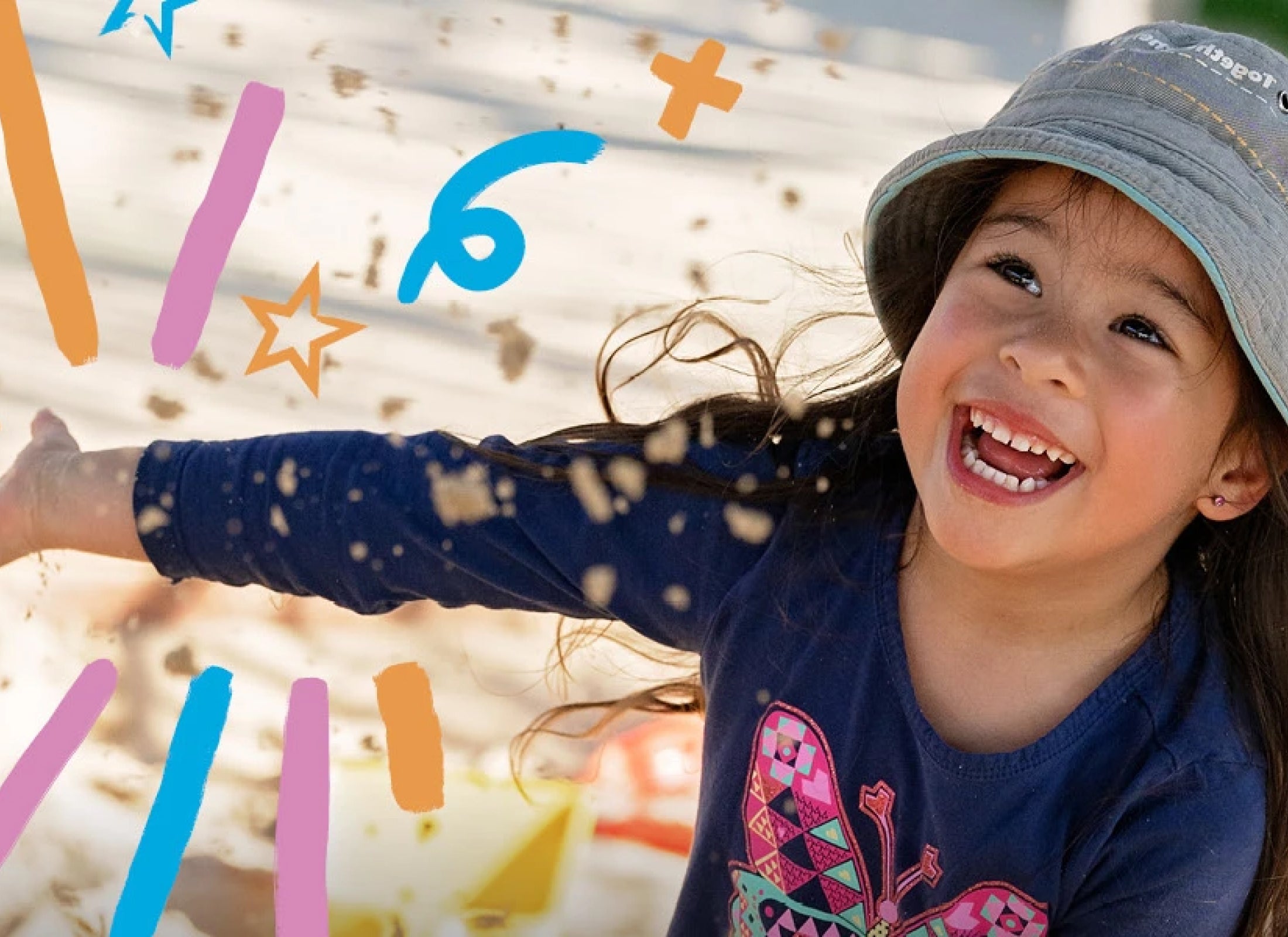 A happy Goodstart child playing in a sandpit